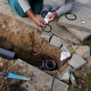 plumber fixing broken sewer line